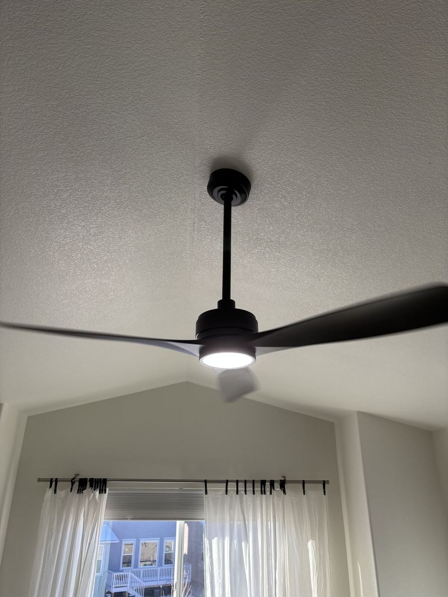 Large ceiling fan in stairway atrium high vaulted ceiling