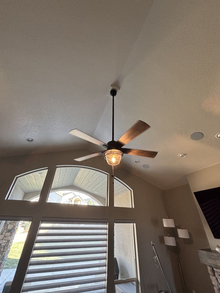 Five-blade ceiling fan with light kit on flat ceiling