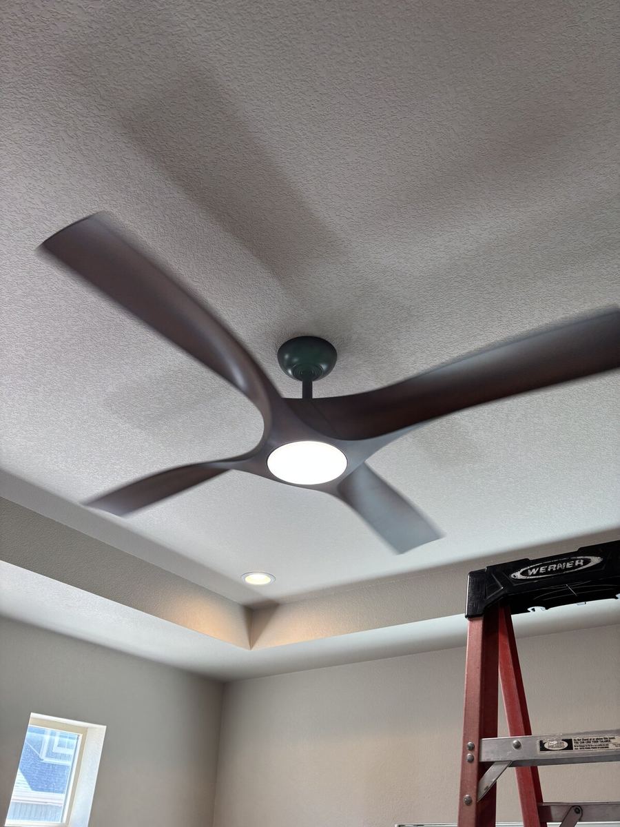 Ceiling fan installed in a residential bedroom with light fixture