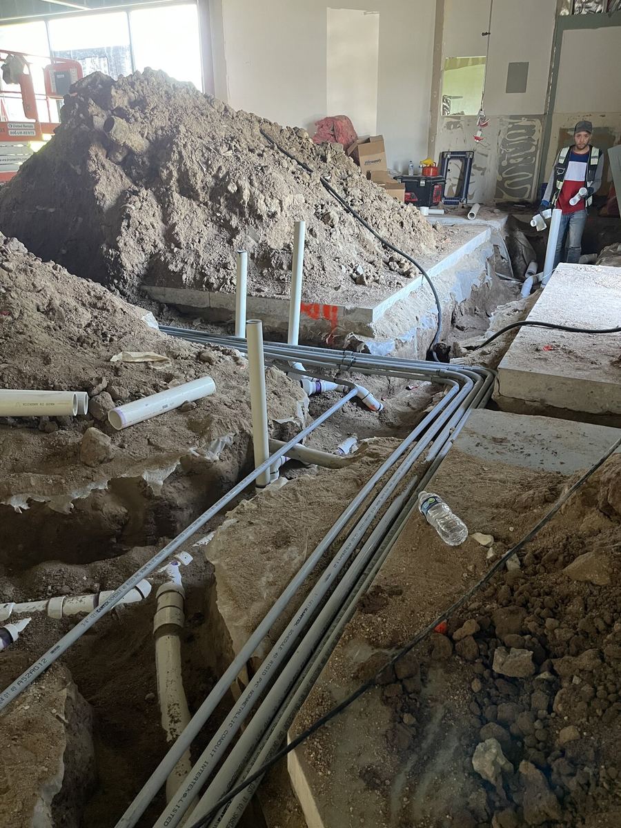 Underground service trench with PVC conduit on commercial site