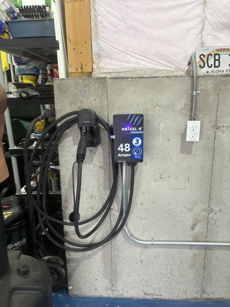 Multiple EV chargers mounted side-by-side in commercial garage