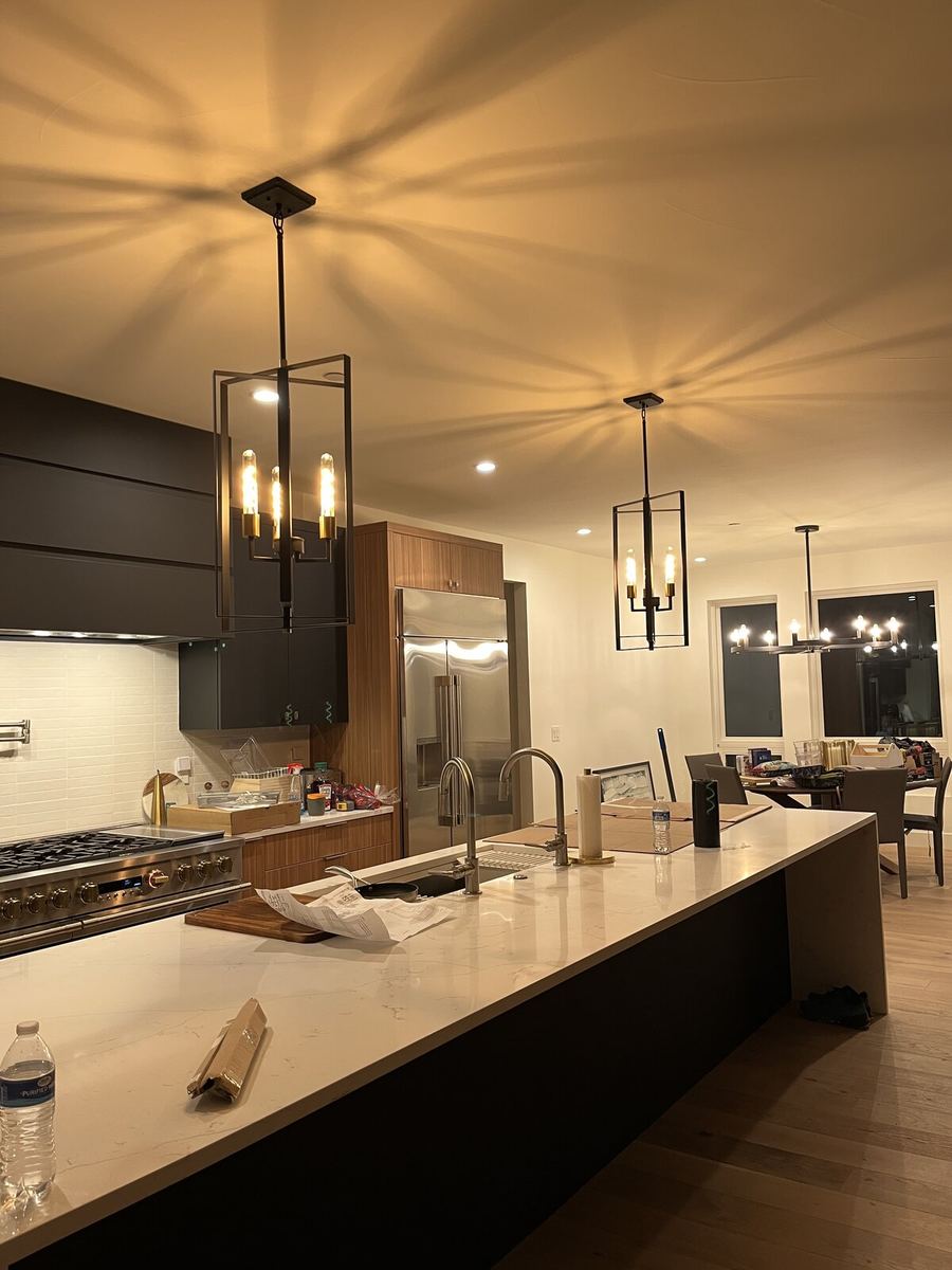 Modern pendant chandelier with crystal accents installed in foyer