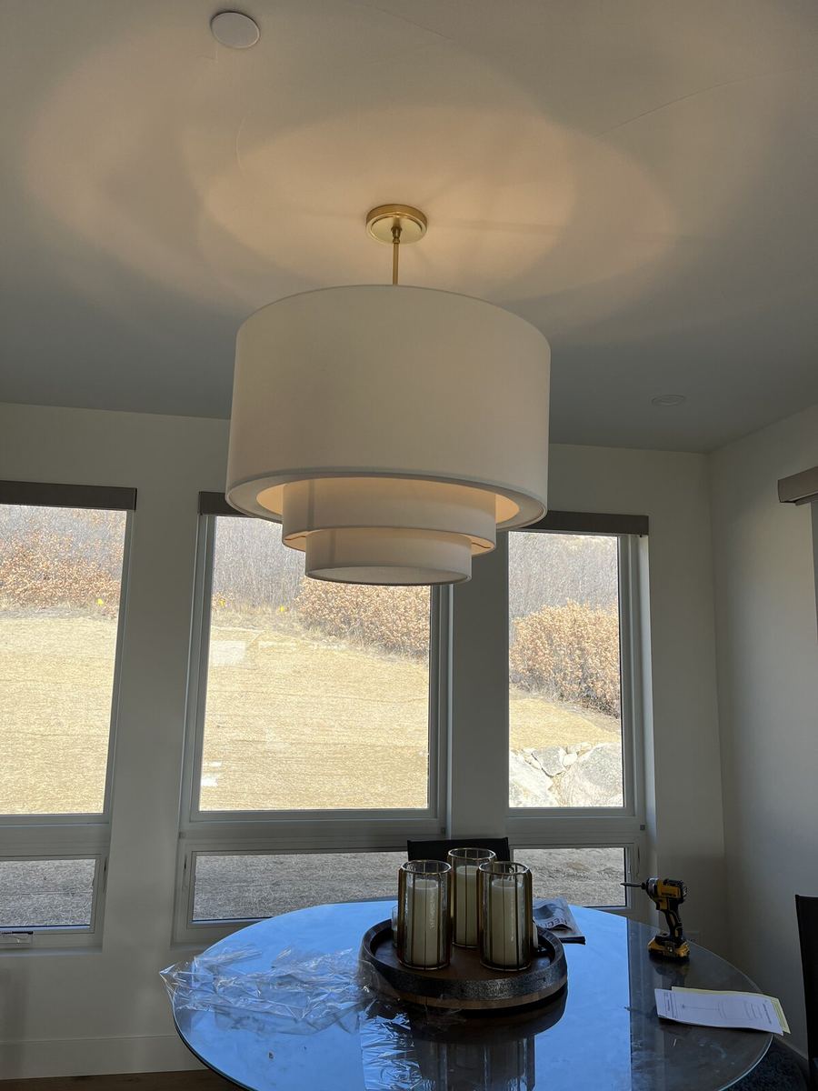 Multiple pendant lights installed over a kitchen island