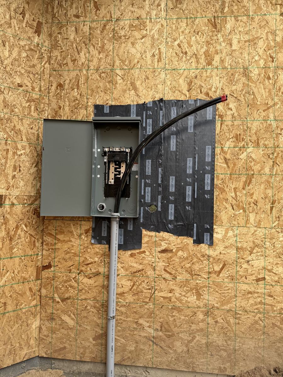 New build rough-in with breaker panel mounted on OSB framing