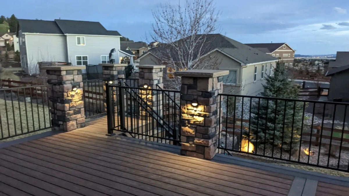 Multi-pillar deck lighting on stone columns at dusk