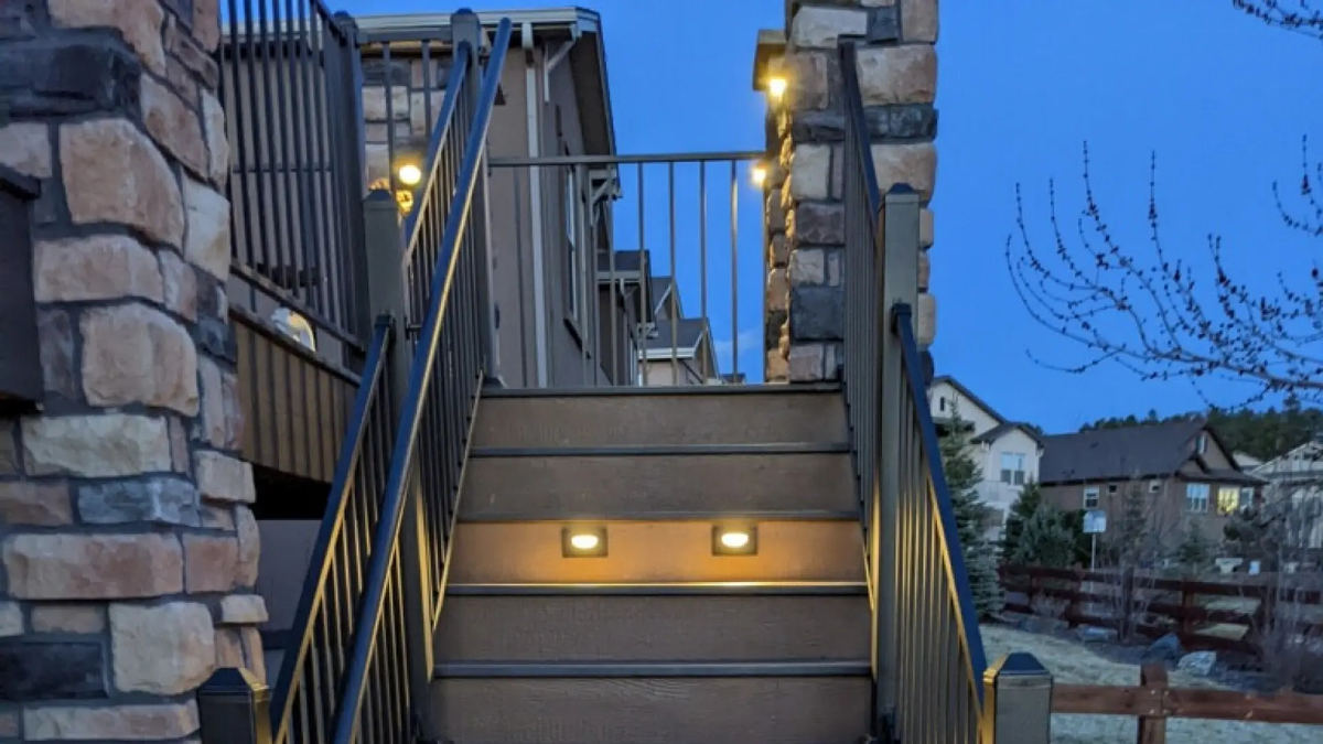 Outdoor stairs with step lights and pillar uplights at blue hour